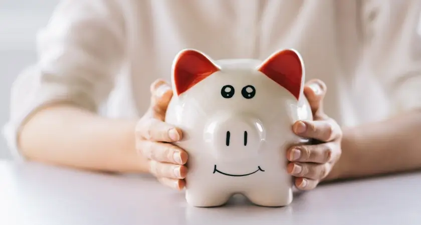 A Woman Holds a Piggy Bank