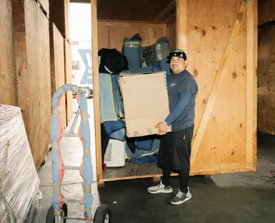 A Walsh worker loads a vault in the warehouse