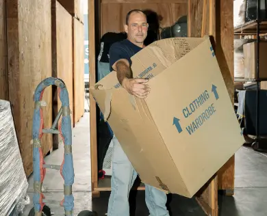 A worker loading a vault in the Walsh warehouse