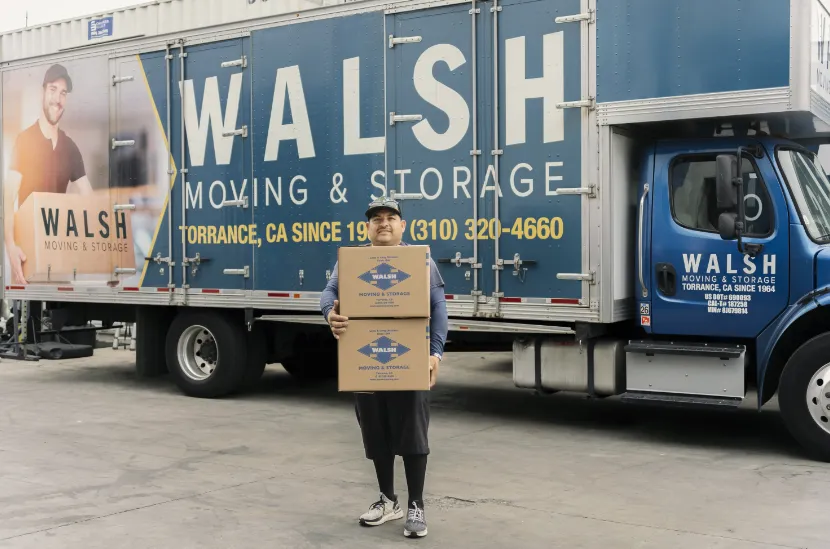 A Walsh worker unloads boxes from truck