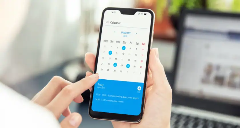 A woman checks her digital calendar