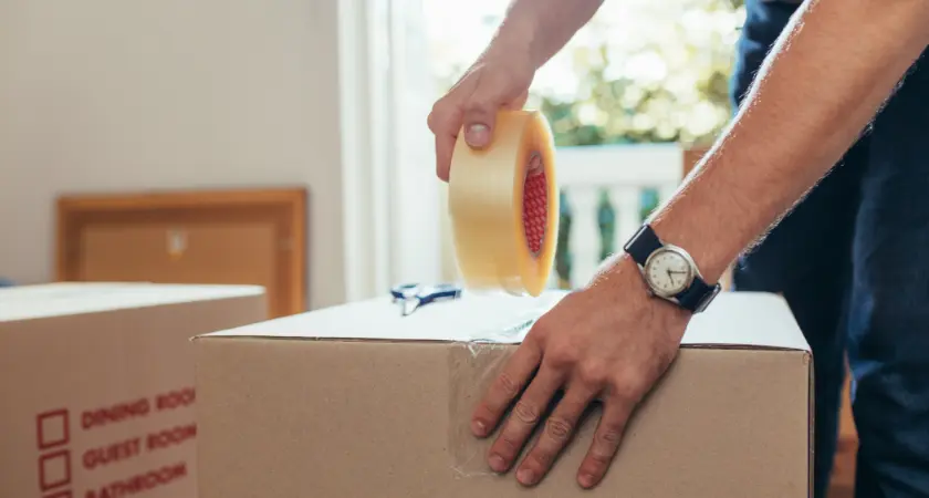 A man packs a box for moving